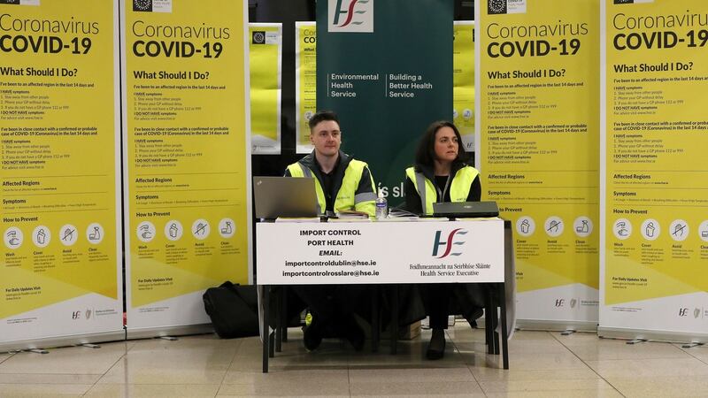 HSE staff who are activating the public awareness campaign for Covid-19 (coronavirus) in the baggage hall of Terminal 2 at Dublin Airport.  Photograph: Brian Lawless/PA