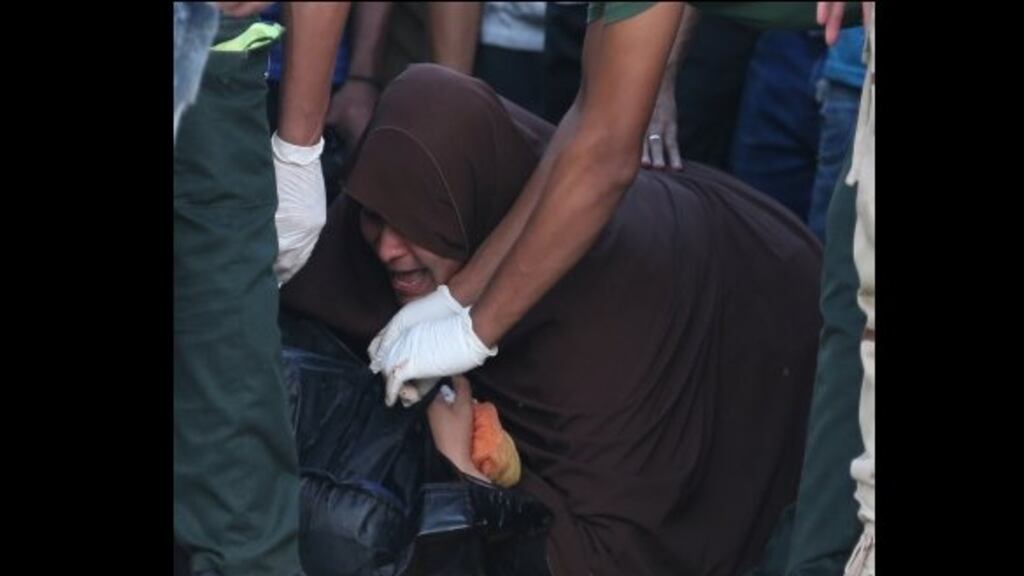 An Egyptian mother is inconsolable beside the body of her son who was aboard a boat carrying migrants which capsized off Egypt’s coast, in Al-Beheira. Photograph: Reuters