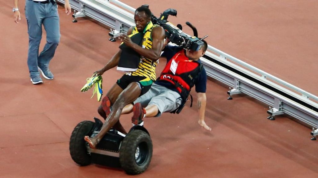 A TV cameraman drives into Usain Bolt of Jamaica after the men’s 200m final during the Beijing 2015 IAAF World Championships at the National Stadium, also known as Bird’s Nest, in Beijing, China. Photograph: Rolex de la Pena/AP