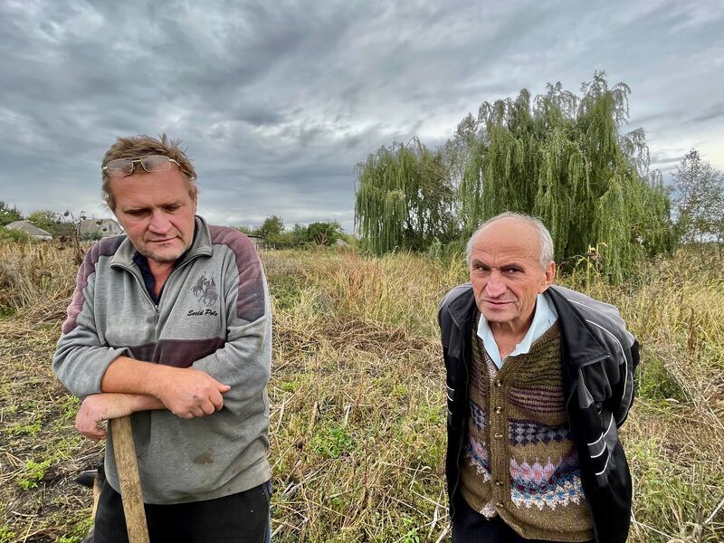 Petro Pivovar and son Andriy talk after Petro and wife Klavdiya returned to their cottage in the village of Mospanove, northeastern Ukraine. Photograph: Daniel McLaughlin