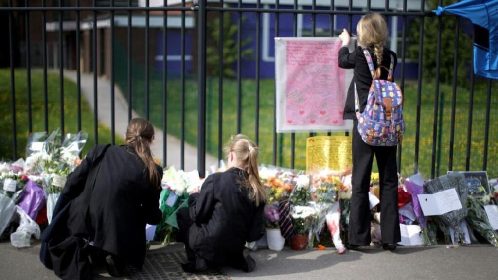 Pupils place tributes to murdered teacher Anne Maguire outside Corpus Christi Catholic College in Neville Road in Leeds today. Photograph: Christopher Furlong/Getty Images