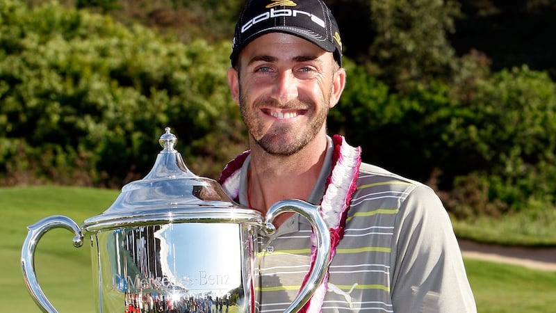 Geoff Ogilvy of Australia holds the trophy after winning the Mercedes-Benz Championship at the Plantation Course in  January  2009. Photograph: Sam Greenwood/Getty Images