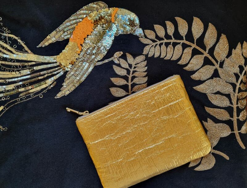 Gold faux leather clutch €85 with embroidered cashmere scarf €295, both from Susannagh Grogan