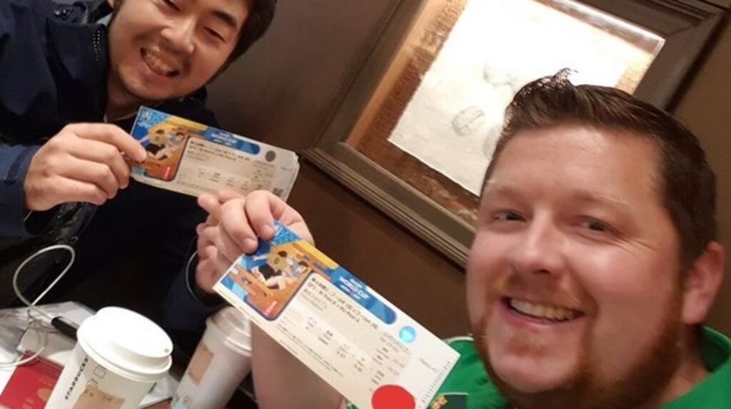 Micheál McAvoy (right) swapping tickets with a Japanese fan. Photograph via the Irish Rugby World Cup Japan Forum Facebook page
