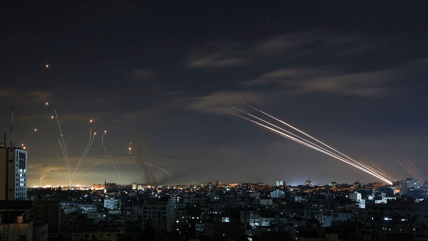 Israel’s Iron Dome missile defence system (left) intercepts rockets fired by the Hamas movement from Gaza city towards Israel early on Sunday. Photograph: Mohammed Abed/AFP via Getty