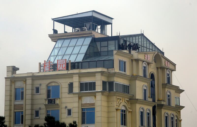 Taliban fighters are seen in the rooftop of a hotel during gunfire in the city of Kabul, Afghanistan. Photograph: AP