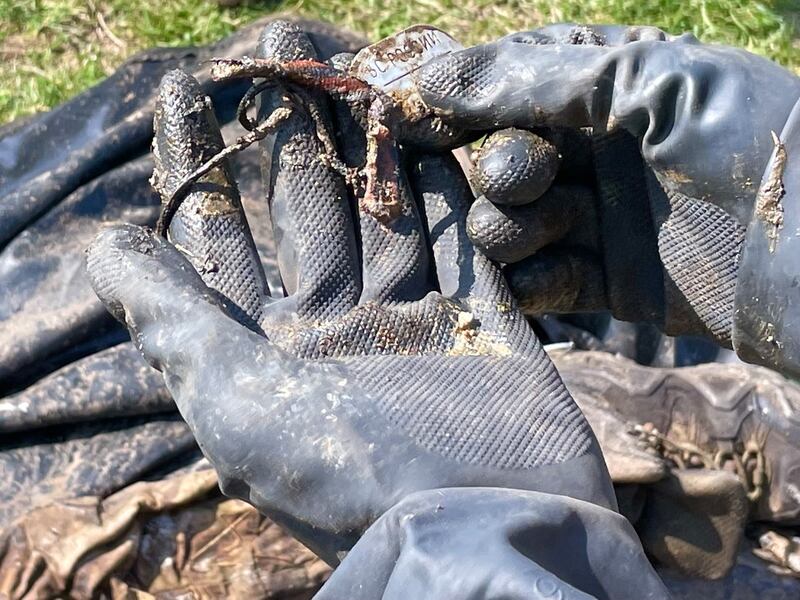 Olexiy Yukov holds a military dog tag found on the body of a soldier retrieved from the battlefield in eastern Ukraine. It identifies the dead man as a member of the Russian armed forces. Photograph: Daniel McLaughlin