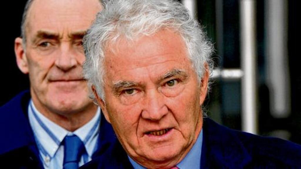 Former Anglo Irish Bank chief Seán FitzPatrick leaving Dublin District Court yesterday with his solicitor Michael Staines. photograph: Cyril Byrne