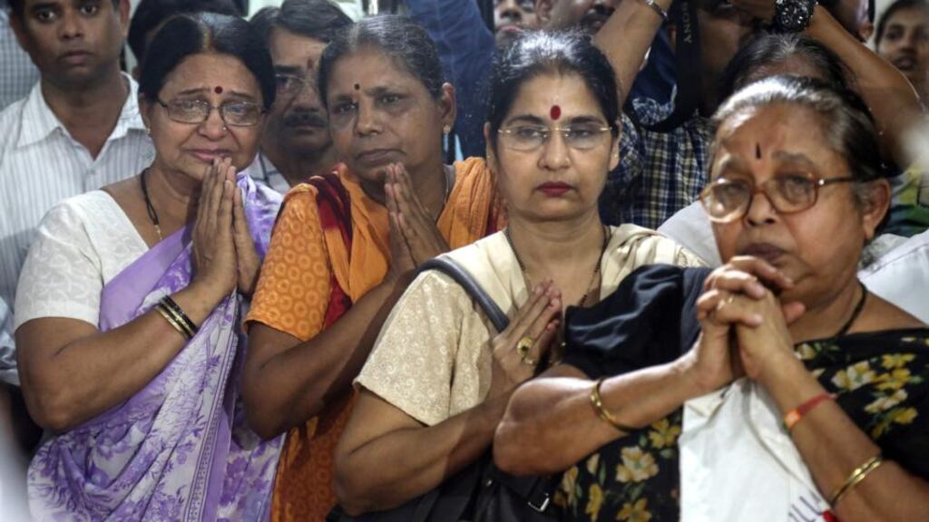 Relatives pay homage to the body of Aruna Shanbaug before the cremation ceremony in Mumbai. The 67-year-old was fed through her nose twice a day for 42 years. Photograph: Divyakant solanki/EPA