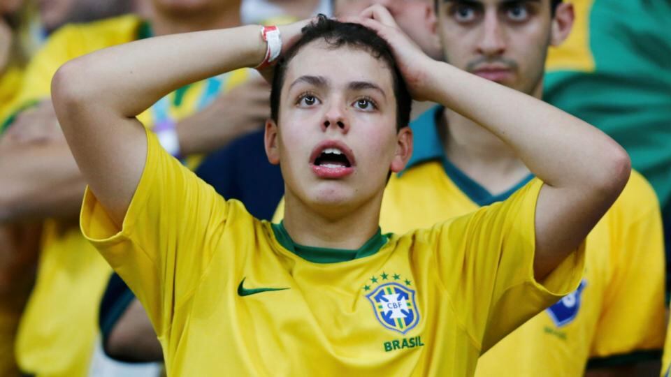 A Brazil fan during their crushing defeat to Germany in Belo Horizonte. Photograph: Marcos Brindicci / Reuters