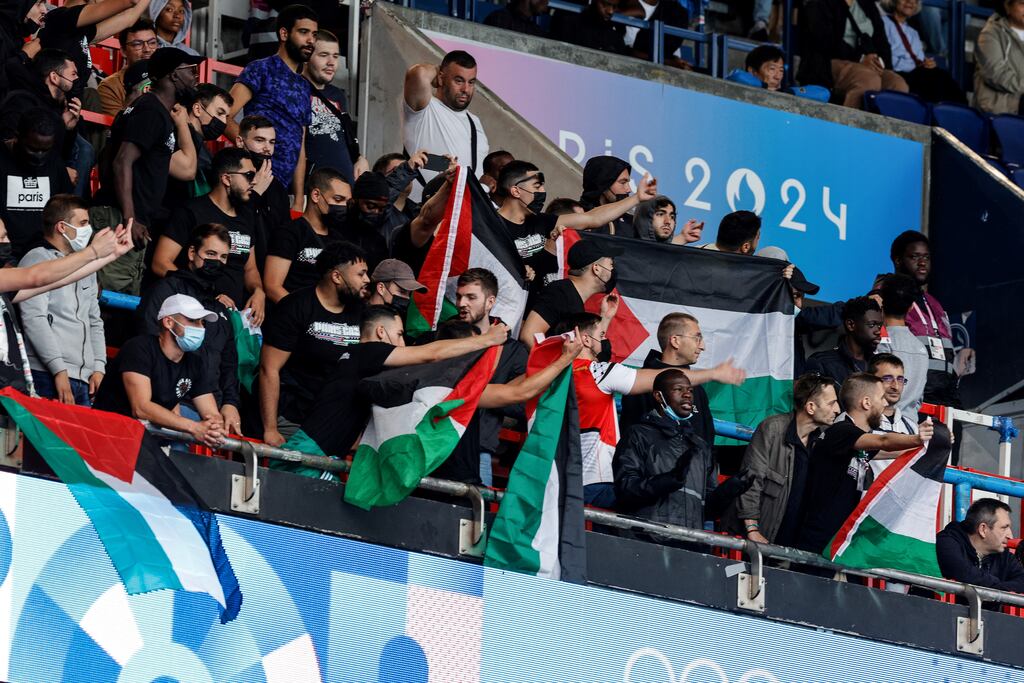 Supporters wave Palestinian flags before the start of the men's group D football match between Israel and Paraguay during the Paris 2024 Olympic Games at the Parc des Princes in Paris on Saturday. Photograph: Geoffroy van der Hasselt/AFP via Getty Images