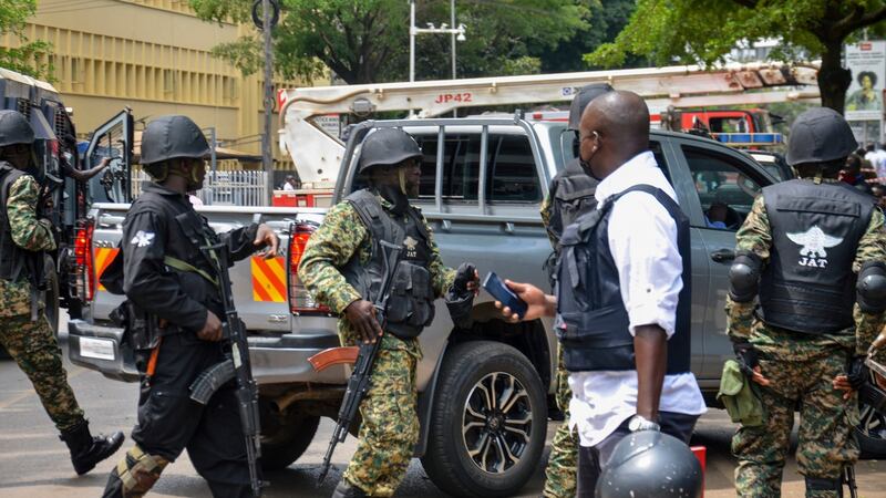 Security forces secure the scene near the parliamentary building in Kampala. Photograph: Ronald Kabuubi/AP