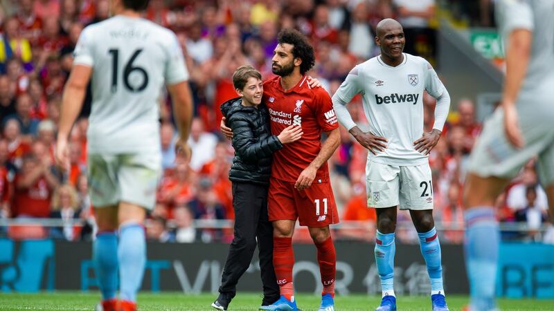 A young fan runs onto the pitch to celebrate Salah’s goal. Photo: Peter Powell/Reuters