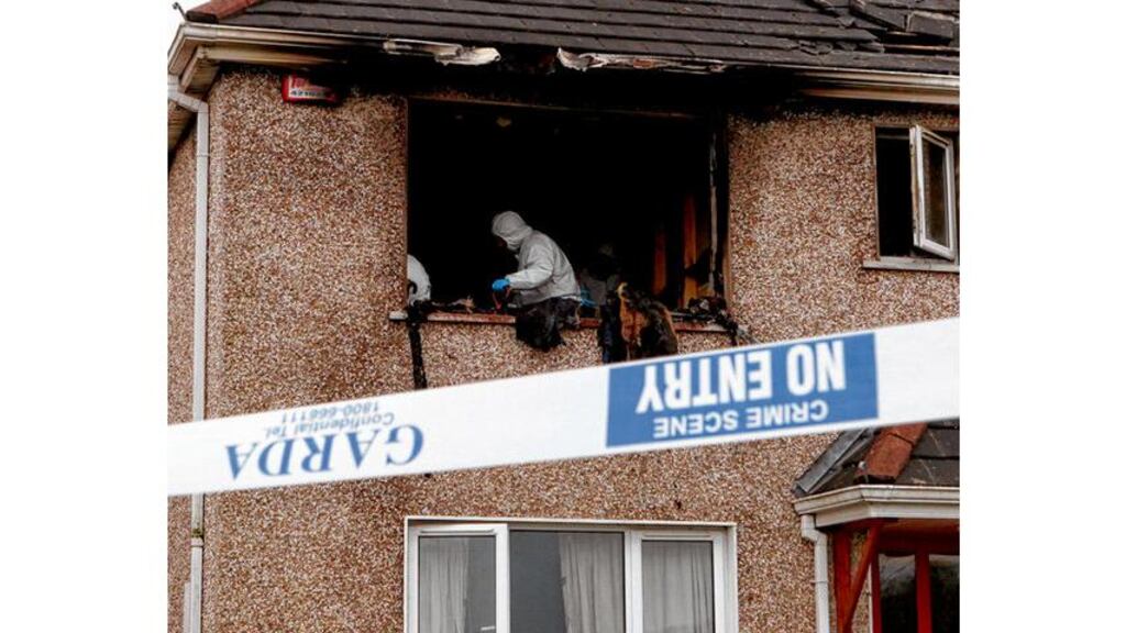 Garda forensic officers at the scene of the fatal house fire in Passage West, Co Cork, yesterday. photograph: darragh kane