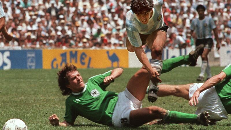 Diego Maradona evades a   tackle from West Germany’s Lothar Matthaus during the 1986 World Soccer Final in Mexico City. Photograph: AFP via Getty Images