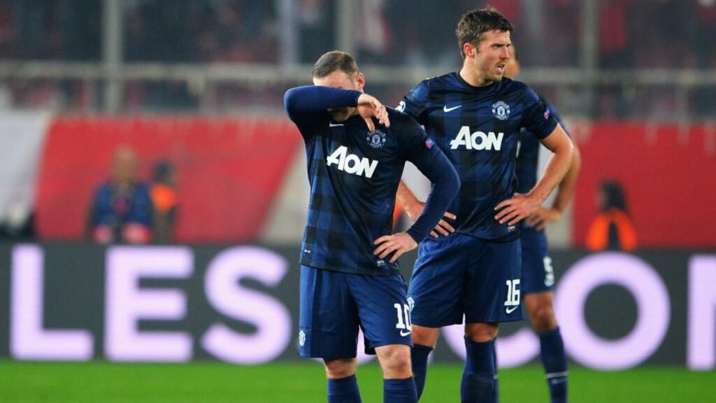 Wayne Rooney and Michael Carrick of Manchester United react as they restart the game after conceding their second goal during the Champions League round of 16 first leg match against Olympiacos FC at Karaiskakis Stadium in Piraeus, Greece. Photograph: Michael Regan/Getty Images