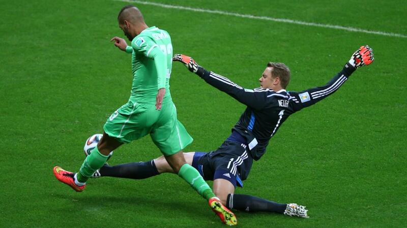 Goalkeeper Manuel Neuer of Germany tackles Islam Slimani of Algeria during theIR World Cup Brazil Round of 16 match at Estadio Beira-Rio in Porto Alegre, Brazil. Photograph: Clive Rose/Getty Images