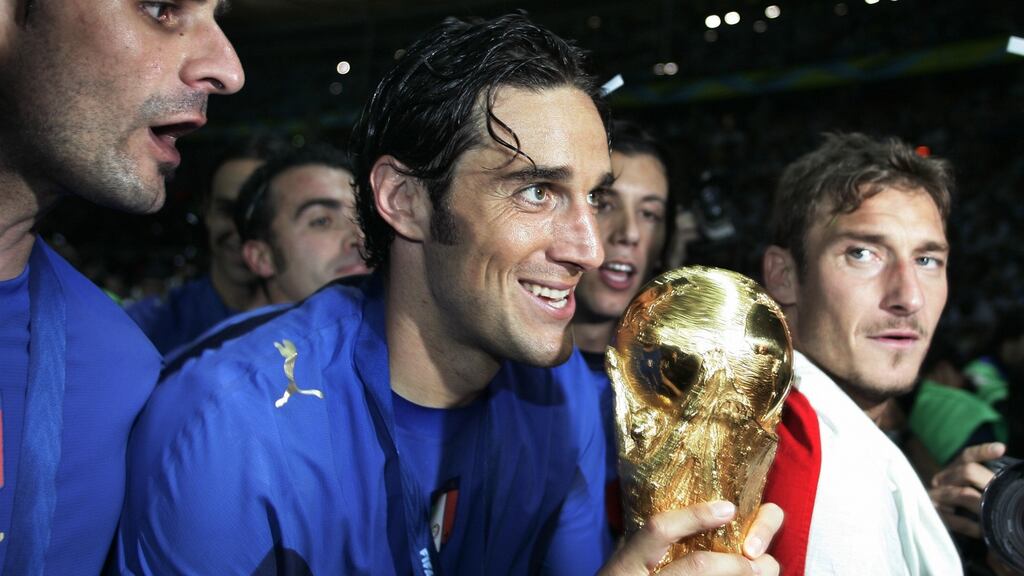 Italian forward Vincenzo Iaquinta (left), Luca Toni (centre) and Francesco Totti (right) pose with the 2006 World Cup trophy. Photo: Pascal Pavani/Getty Images