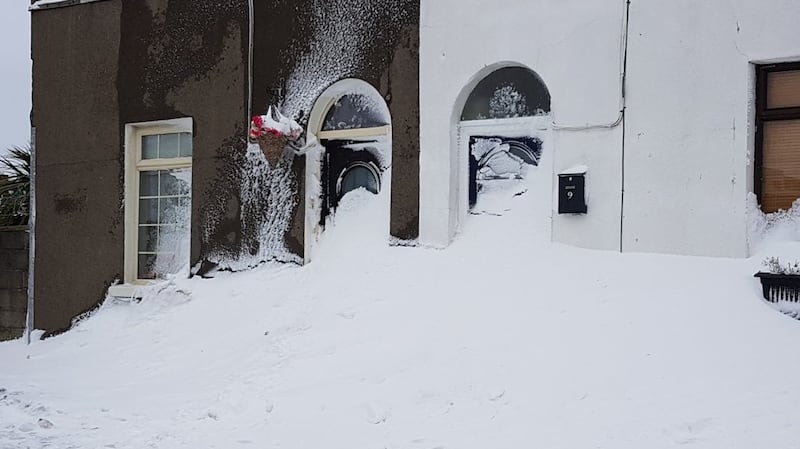 Houses in Inchicore, south Dublin, with their front doors blocked by drifting snow. Photograph: Gavin Ó Ceallacháin