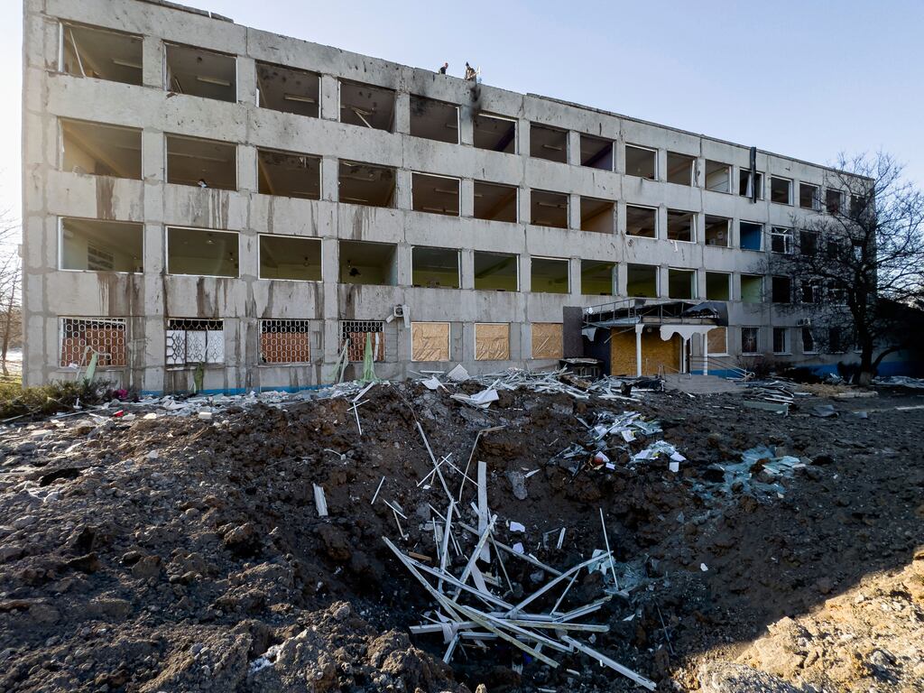 Municipal workers clear the rubble on the roof of College No. 47 which was damaged by a Russian rocket attack in Kramatorsk. Photograph: AP