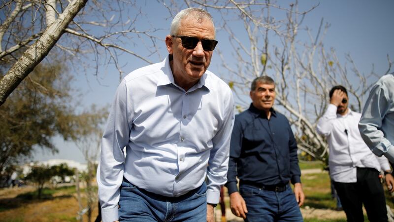 Benny Gantz, one of the leaders of Blue and White, leans forward during a visit to Kibbutz Kfar Aza, outside the northern Gaza Strip, in southern Israel. Photograph: Amir Cohen