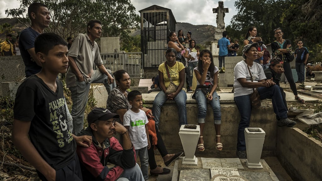 Friends of Jesús Contreras placed a radio at his grave, playing salsa and reggaeton music. Photographs: Meridith Kohut for The New York Times