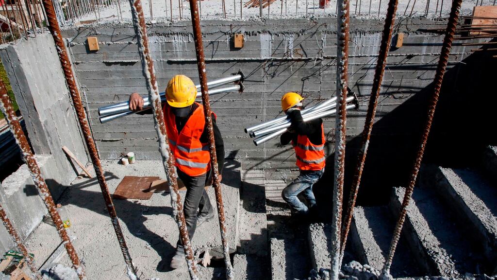 Construction workers at the site of a school funded by the US United States Agency for International Development in the Palestinian village of Al-Jabaa, 15km southwest of Bethlehem. Photograph: Hazem Bader/AFP