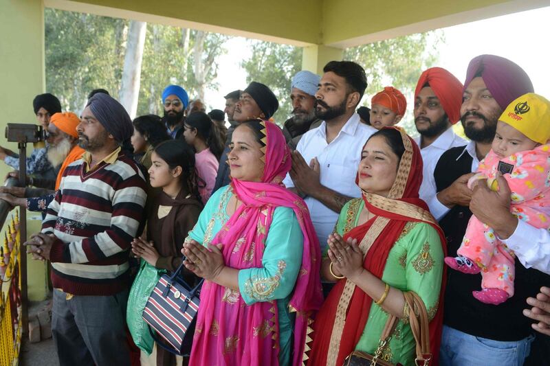 Indian Sikh devotees offers prayers as they look towards the Gurdwara Kartarpur Sahib, which is situated in Pakistan, from Indian side at Dera Baba Nanak on the outskirts of Amritsar on November 25th Photograph: Narinder Nanu/AFP/Getty