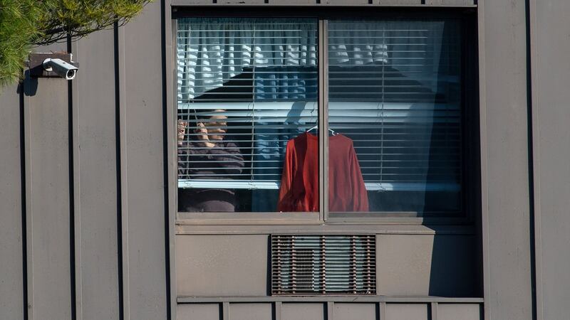 A resident looks through a window at Andover Subacute and Rehabilitation Center in Andover, New Jersey. Photograph: Gregg Vigliotti/The New York Times