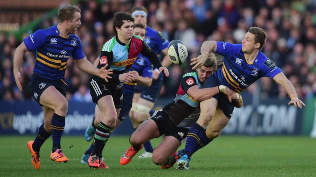 Leinster’s Jimmy Gopperth  hands the ball off to Luke Fitzgerald despite the tackle of Luke Wallace of Harlequins during last weekend’s European Rugby Champions Cup. Photo: Jamie McDonald/Getty Images