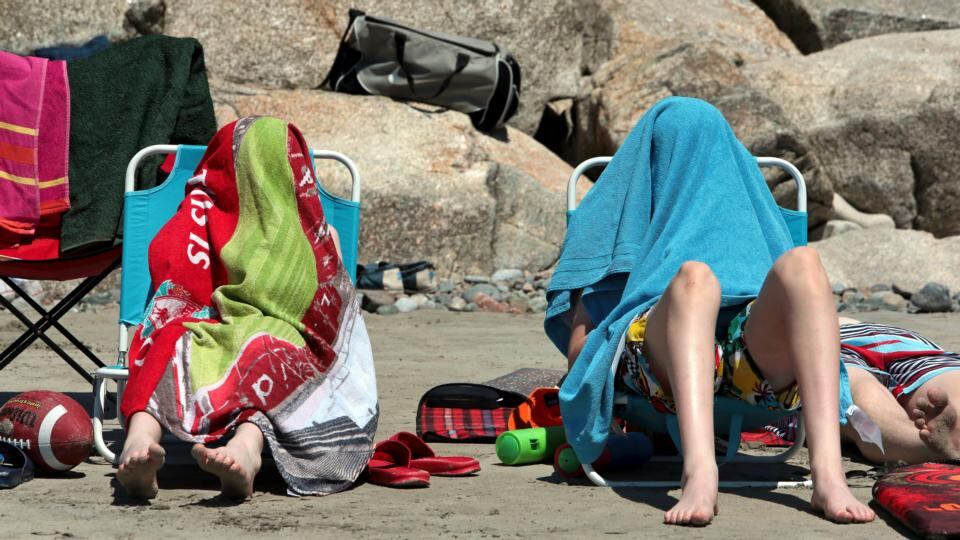The sun proved a little too hot and bright for some people on the beach at Blackrock in Galway. Photograph: Joe O’Shaughnessy