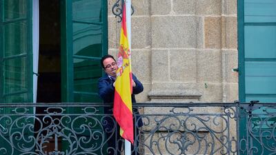 An employee sets the Spanish flag at half mast on a balcony of the council of Betanzos, northwestern Spain. One of the victims was Aysha Frade, a daughter of a Galician mother from Betanzos. Photograph: Miguel Riopa/AFP/Getty Images
