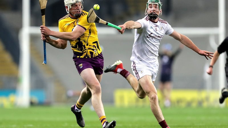 Cathal Mannion gets a tackle in on Liam Ryan. Photo: Laszlo Geczo/Inpho