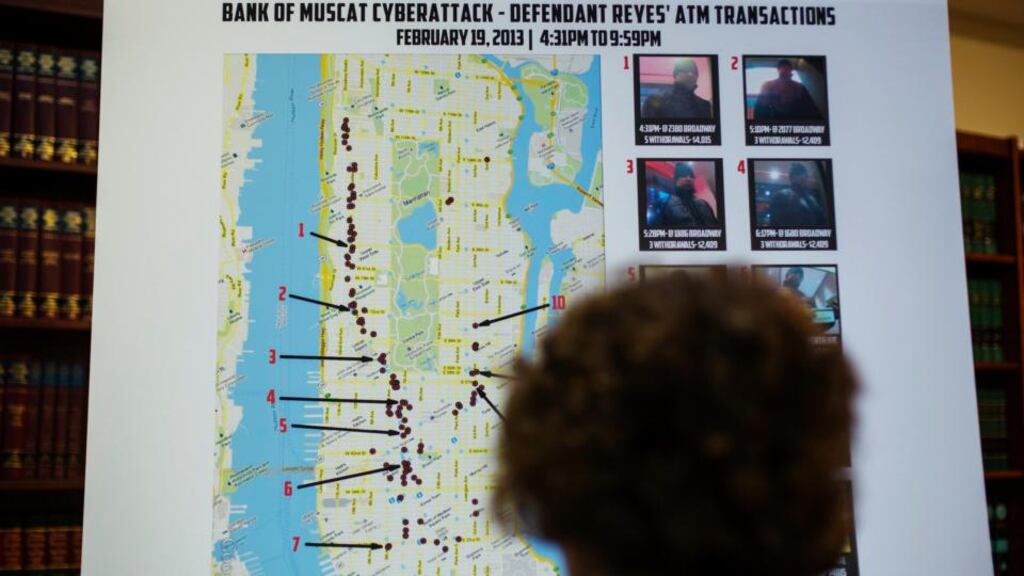 A woman looks at a map showing where eight members belonging to a New York-based cell of a global cyber criminal organization withdrew money from ATM machines, during a news conference in New York. Photograph: Lucas Jackson/Reuters