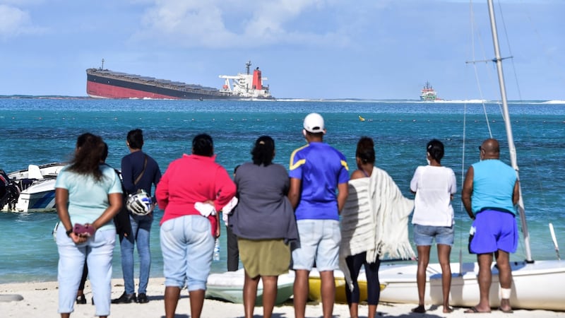 People look at MV Wakashio bulk carrier that ran aground off southeast Mauritius. Photograph: Dev Ramkhelawon/L’Express Maurice/AFP/Getty Images