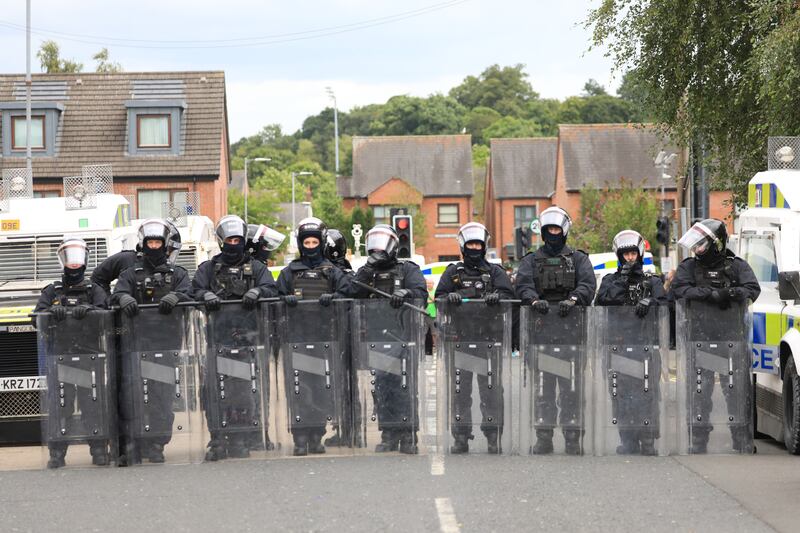 Riot police form a line on the Lower Ormeau Road during unrest in Belfast. Photograph: Peter Morrison/PA Wire