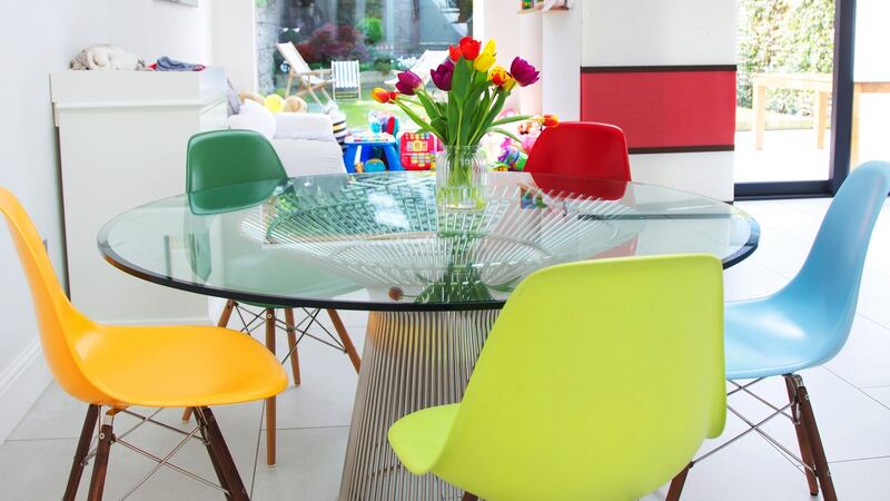 This wire frame glass top table is a copy of the 1966 design by Warren Platner. It is surrounded by replicas of the Eames DSW chair, in a rainbow of colours. Photograph: Emily Quinn
