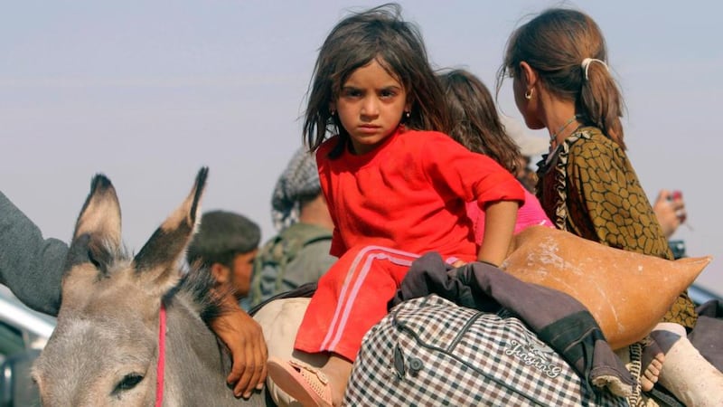 Displaced children from the minority Yazidi sect fleeing violence from forces loyal to the Islamic State in the town of Sinjar head towards the Syrian border, on the outskirts of Mt Sinjar, near the Syrian border town of Elierbeh of Al-Hasakah Governorate. Photograph: Reuters/Rodi Said