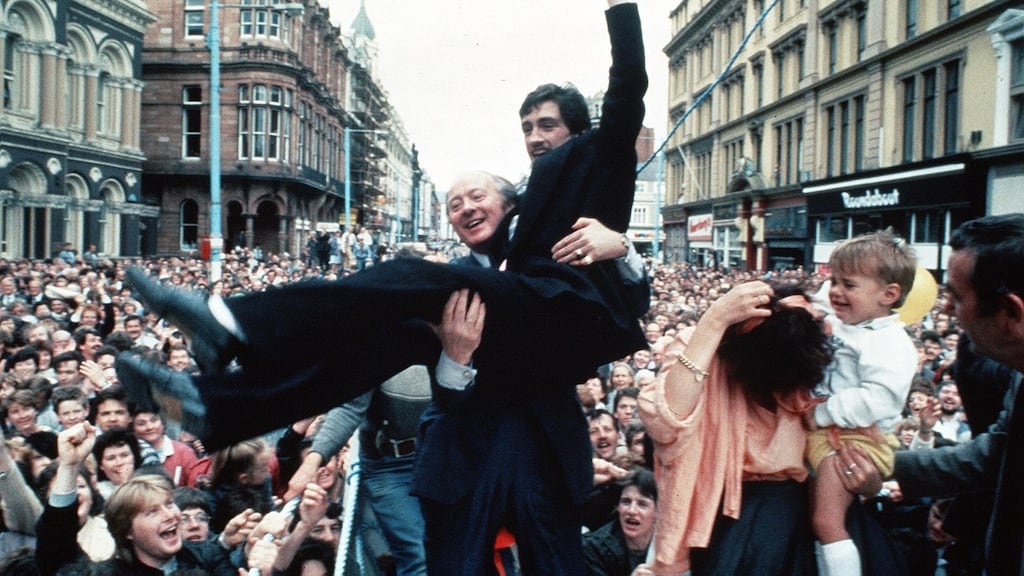 Barry McGuigan held aloft by manager Barney Eastwood on his return to Belfast – with wife Sandra and son Blain – after beating Eusebio Pedroza at Loftus Road, London, to win the WBA world featherweight title in 1985. Photograph: Pacemaker
