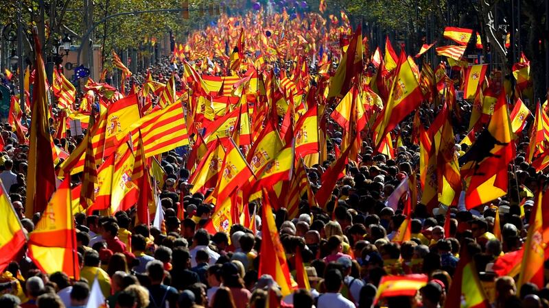Protesters wave Spanish and Catalan Senyera flags during a pro-unity demonstration in Barcelona. Photograph: Pierre-Phillippe MarcouAFP/Getty Images
