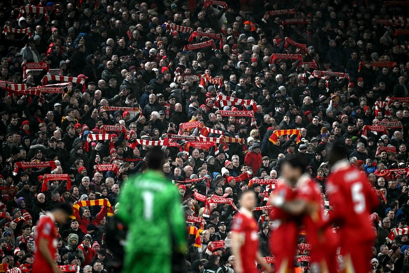 Fans hold scarves before the English Premier League football match between Liverpool and Newcastle United at Anfield. Photograph: Paul Ellis/AFP via Getty