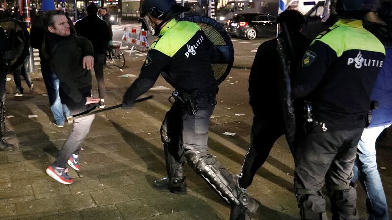 Demonstrators scuffle with Dutch riot police outside the Turkish consulate in Rotterdam on Sunday. Photograph: Reuters