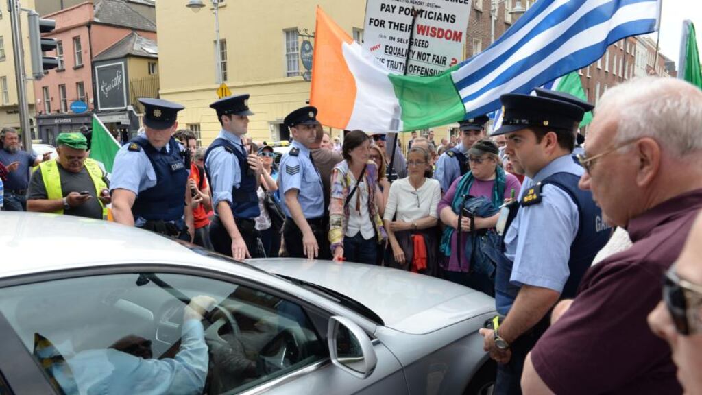 Anti-water charge protesters outside the gates of Leinster House, Dublin, July 1st, 2015. Photograph: Dara Mac Dónaill/The Irish Times