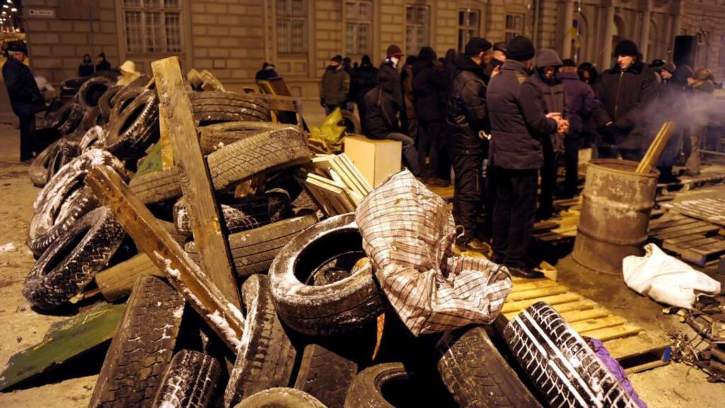 Protesters build a barricade in a street in front of the state administration headquarters in Lviv, Ukraine, this evening. Photograph: Darek Delmanowicz/EPA