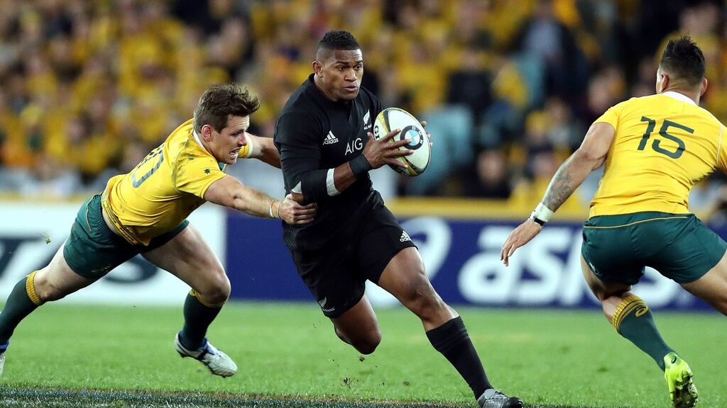 New Zealand’s Waisake Naholo gets by Bernard Foley of Australia during Saturday’s victory over their rivals. Photograph: Paul Seiser/Inpho