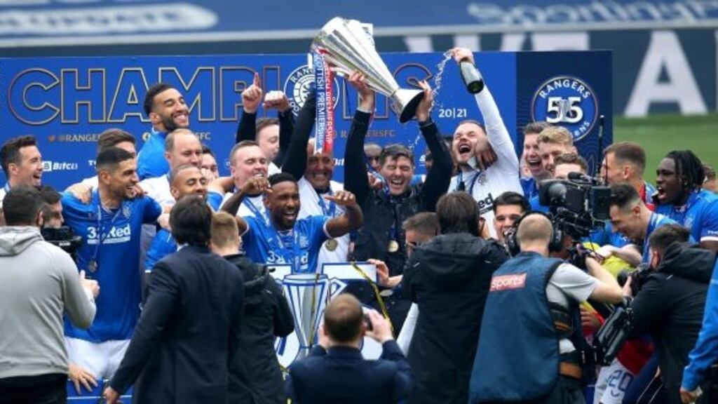 Rangers manager Steven Gerrard celebrates with the trophy after winning the Scottish Premiership at Ibrox Stadium. Photo: Andrew Milligan/PA Wire