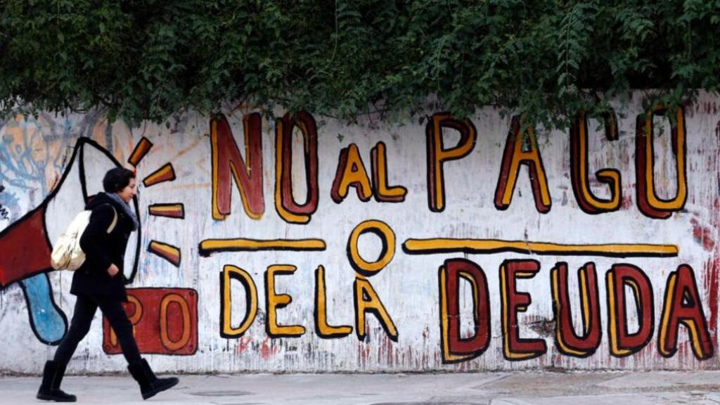 Graffiti that reads “No to the debt payment” in Buenos Aires; the city defaulted on some €80.2 billion of its bonds in 2002. Photograph: Marcos Brindicci/Reuters