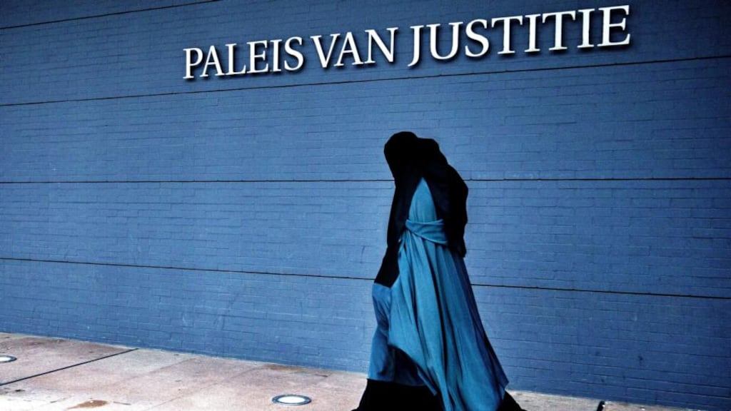 A woman wearing a burqa walks past the Palace of Justice in The Hague. The Dutch cabinet on Friday approved a partial ban on wearing face-covering. Photograph: Jerry Lampen/AFP/Getty Images