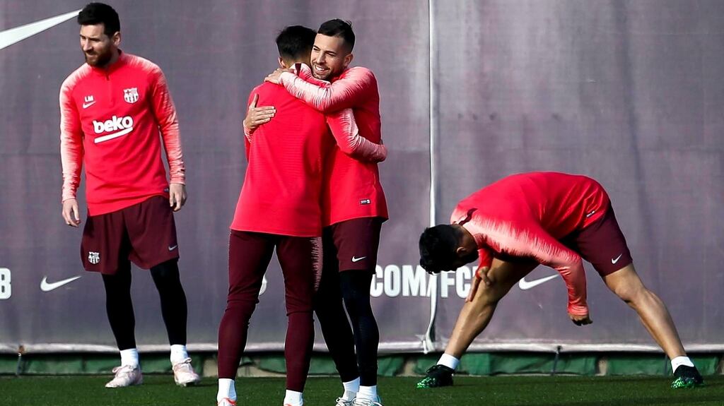 Barcelona’s Lionel Messi (L) and Jordi Alba hug during a training session ahead of the Champions League semi-final. Photo: Enric Fontcuberta/EPA