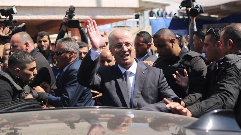 Palestinian prime minister Rami Hamdallah waves to the crowd upon his arrival in Gaza City on Tuesday. Photograph: Mahmud Hams/AFP/Getty Images